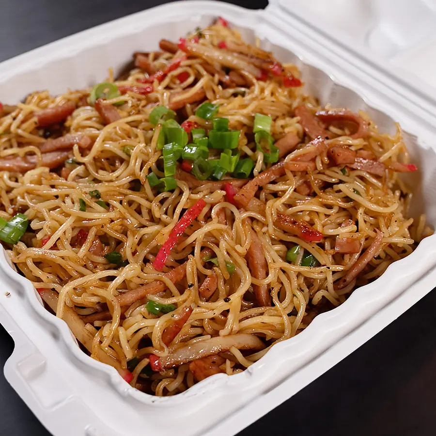 A take-out box of Hawaiian-style fried noodles with sliced vegetables and garnished with green onions from Pua's Plate Lunch catering.