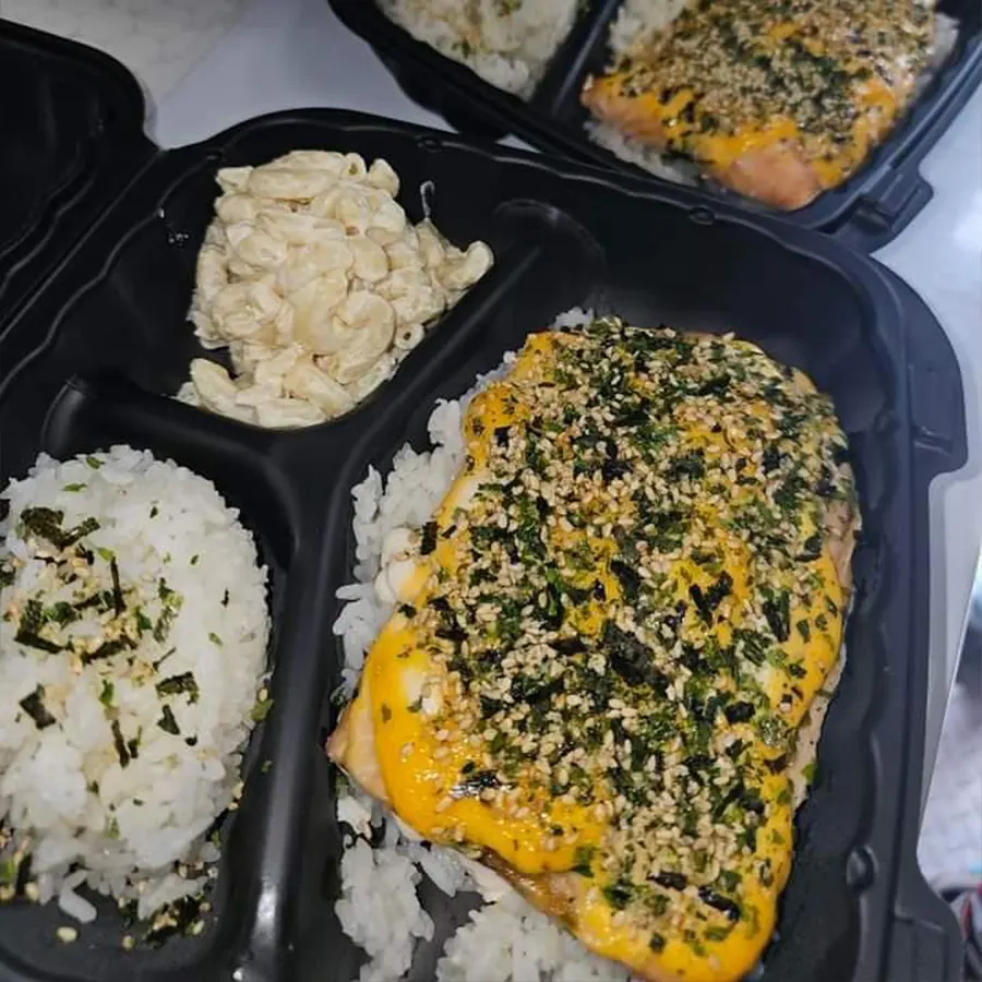 Hawaiian plate lunch with furikake-topped salmon, rice, and macaroni salad, representing Pua's Plate Lunch catering services.