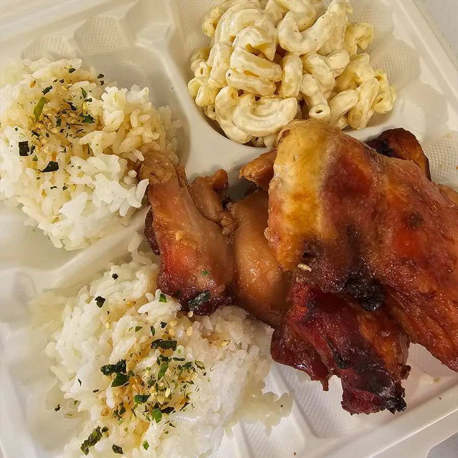 Plate of Hawaiian Teri Chicken with seasoned rice, roasted meat, and macaroni salad from Pua's Plate Lunch catering.